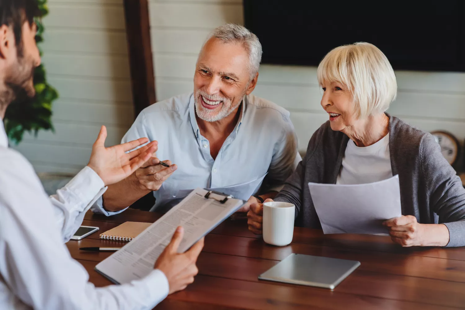 Happy elderly couple talking with an advisor